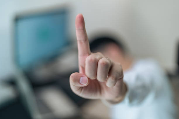 Man using a fingerprint scanner module built into a laptop, finger sliding on the fingerprint sensor detail closeup, one person. Biometric authentication, authenticating using a finger print signature