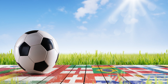 International flags on a wooden walkway and football ball: football world cup championship concept