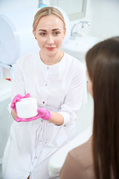 istock Female showing jar with gel for face cleaning 1949532944