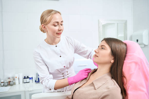 istock Medical worker on cosmetology procedure with client 1949532952