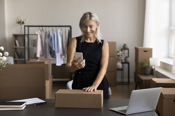 istock Female designer, own brand founder use mobile app in office 1949544549
