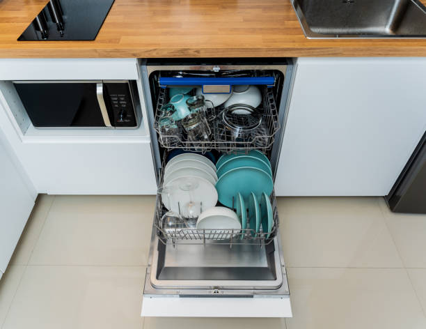 istock The white kitchen and opened dishwasher with clean dishes 1949550349