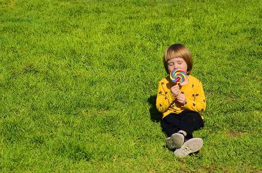 Beautiful little girl with camera, summer outdoor