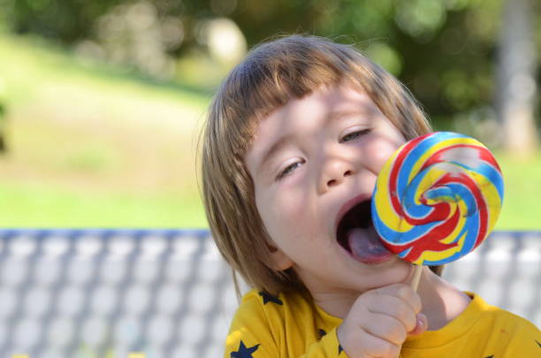 istock Space for text, child enjoys life. A boy in kindergarten eats Lolipop 1949554101