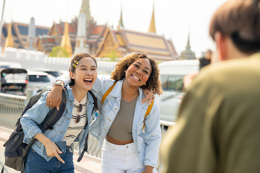 Group of  people tourist travel Temple in Thailand.Young tourist women exploring in the city of southeast Asia by using map for navigate to destination.