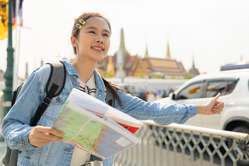 Young couple asian tourist travel Temple in Thailand.Young tourist women exploring in the city of southeast Asia by using map for navigate to destination.