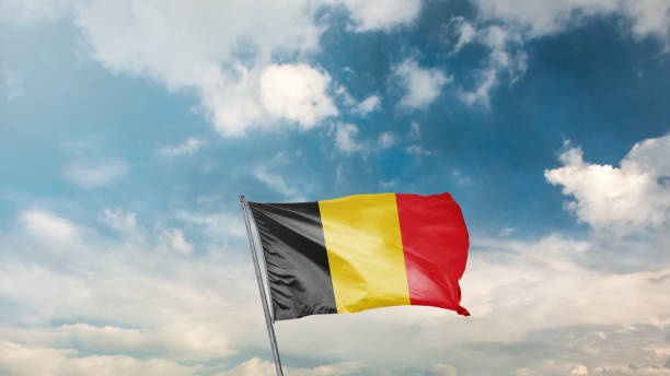 istock flag of belgium on blue sky background 1949561194