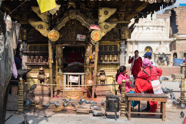 Kathmandu, Nepal- April 20,2023 : People visit the ancient stupas of Swayambhunath temple high above Kathmandu.