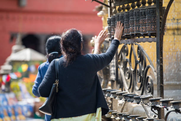 Kathmandu, Nepal- April 20,2023 : People visit the ancient stupas of Swayambhunath temple high above Kathmandu.