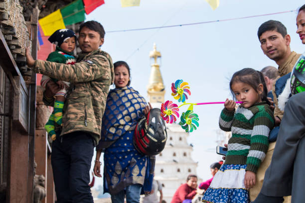 Kathmandu, Nepal- April 20,2023 : People visit the ancient stupas of Swayambhunath temple high above Kathmandu.