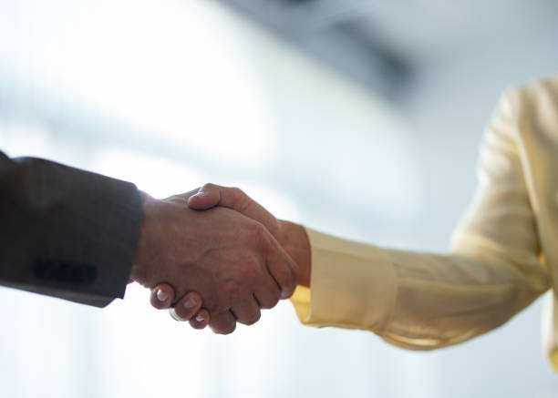 istock Close Up Shot of Two Anonymous Businesspeople Shaking Hands 1949596168