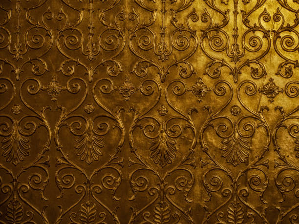 istock Old golden ornament on the wall 1949602669
