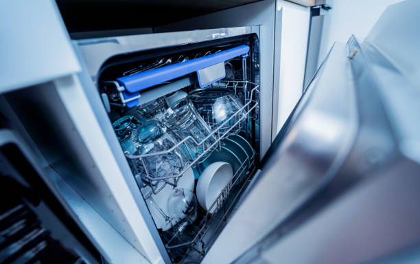 istock The white kitchen and opened dishwasher with clean dishes 1949611643