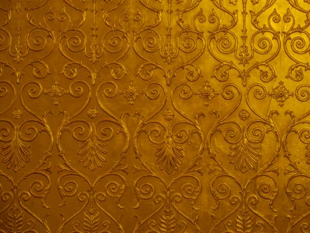 istock Old golden ornament on the wall 1949613707