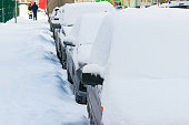cars parked near the sidewalk covered with snow