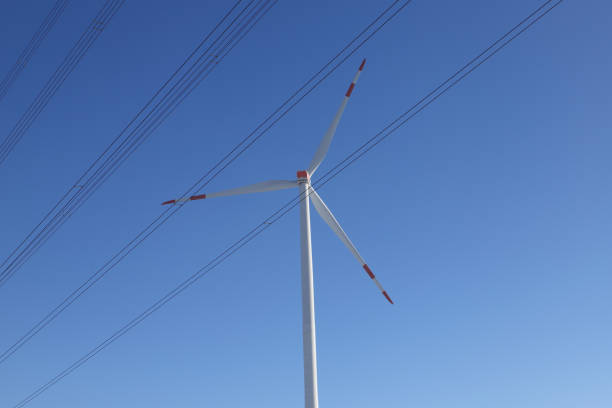 Wind turbine on a field with blue sky