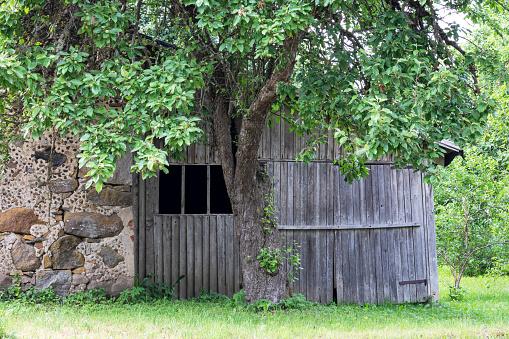 Old boulder barn wall with old wooden plank barn