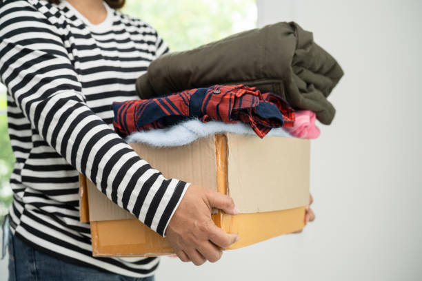 istock Donation box with used clothes at home to support help for poor people in the world. 1949690328