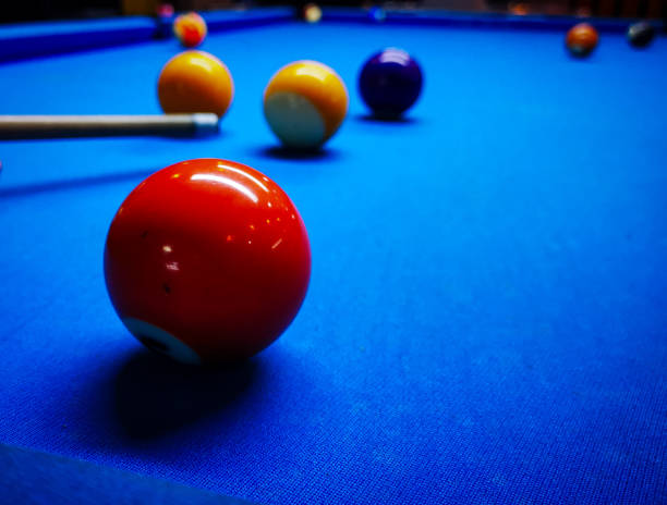istock Game of pool with multiple balls and pool cue focus on a single ball. 1949700973