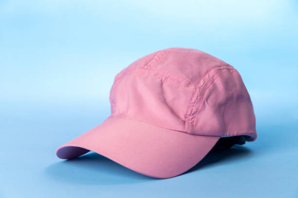 istock Pink women's cap on blue background. 1949704037