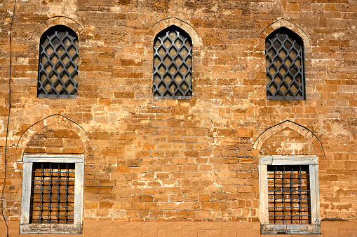 Wall from coquina (shell stone, shell rock, limestone) and windows of ancient Turkish mosque