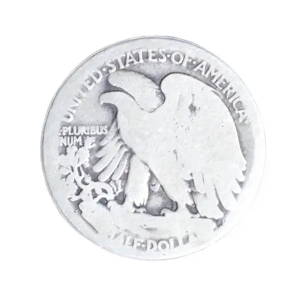 Photo of old vintage worn Walking Liberty half dollar is a silver 50 cent piece or half dollar coin that was issued by the United States S Mint from 1916 to 1947 reverse back view isolated on white background