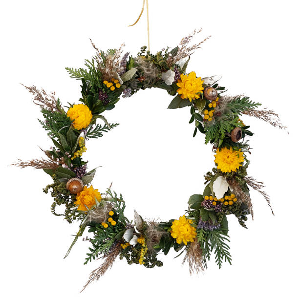 Spring flat lay of a beautiful floral wreath of almond blossoms, dried flowers, eucalyptus leafs, crumbs of the lavender blossom and petals on bright grunge background with copy space in the centre. Color editing and added grain. Part of a series.