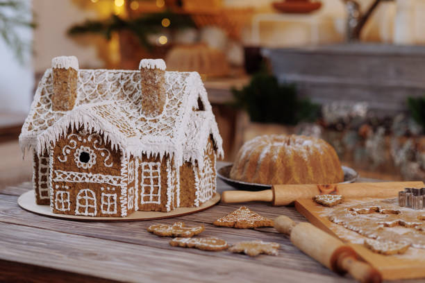 istock Gingerbread house on a wooden table in a Christmas loft kitchen 1949758716