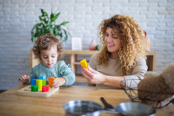 istock Mother and daughter playing in kids room 1949804826