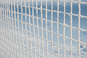 Detail of a chain-link fence, covered with hoarfrost