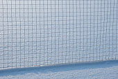Metal fence on a snowy field