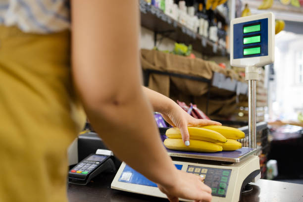 istock Sales person weighing bananas 1949824054