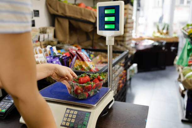 istock Sales person weighing strawberries 1949824244