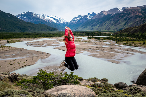 Tourist jumping for happiness in Patagonia Argentina. Happy tourist touring the south of Argentina. Tourist jumping for happiness