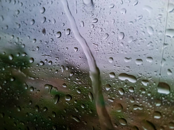istock Rain drops on the window glass at the train in travel 1949832582