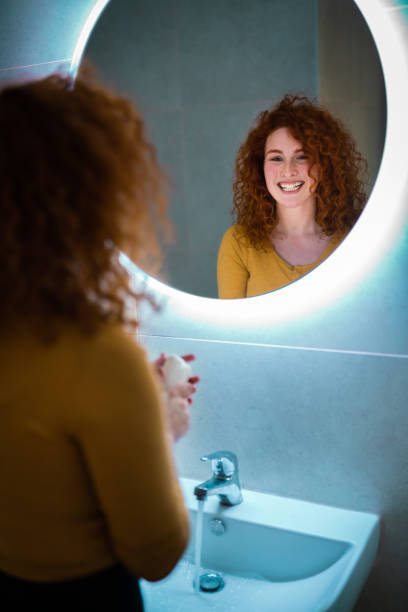 istock Beautiful young woman smiling in the mirror 1949836853