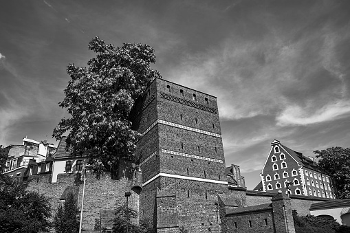 historic medieval defensive walls with a leaning tower in the city of Torun, Poland