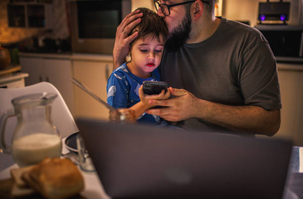 istock young dad uses laptop and pays bills while son tries to distract him 1949854809