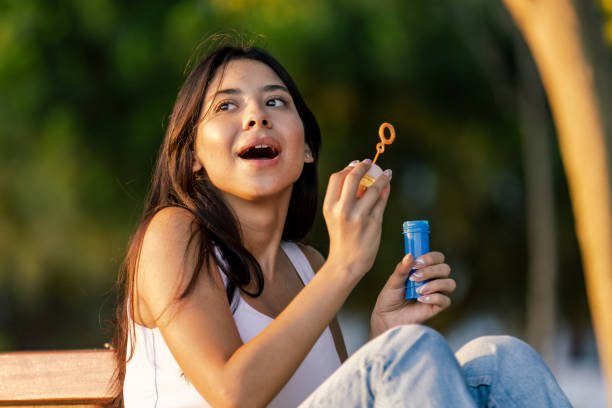 istock Black haired young woman is enjoying bubbles. 1949855861