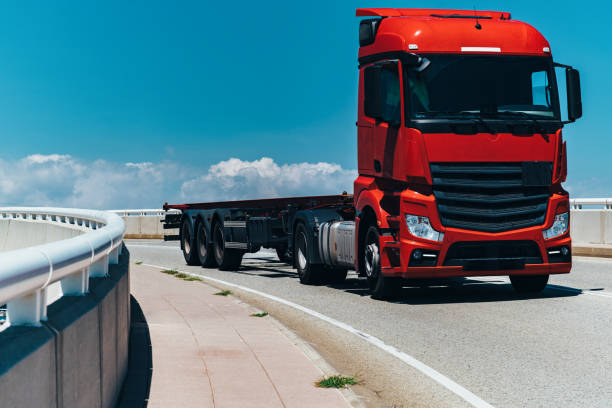 istock Red truck without trailer driving on a bridge at summer day 1949896918