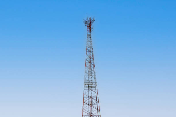 Internet signal tower or mobile phone signal tower is isolated on blue sky background texture. Global communication and internet network connection concept