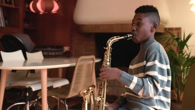 Young Musician: Son Hones Saxophone Skills in Home Practice Session