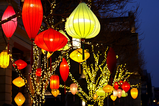 The photo was taken on Qianmen Street, Beijing, during the Lantern Festival. It's a Chinese traditional festival celebrated on the fifteenth day of the first month in the Chinese calendar and will come in the next month this year. On the night, people will take to the streets to admire lanterns, eat Tangyuan, guess lantern riddles and set off fireworks. Various lanterns are hung on the streets, especially in some famous scenic spots for tourists to watch and take photos. Chinese couplets will also be pasted on both sides of the front door and a four-character horizontal scroll affixed above the doorframe, as shown in the picture. Which expresses people's wishes for a better life in the coming year.
