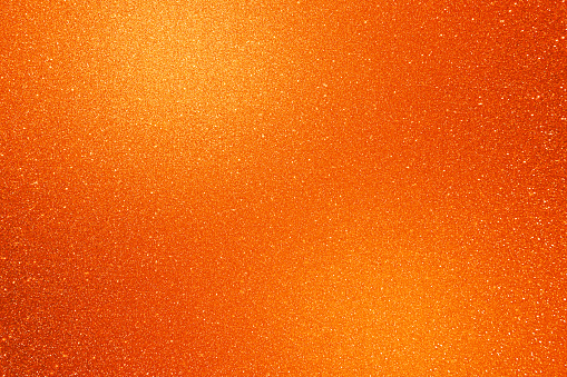 Golden brown yellow glitter texture abstract banner background with space. Twinkling glow stars effect. Like outer space, night sky, universe. Rusty, rough surface, grain.