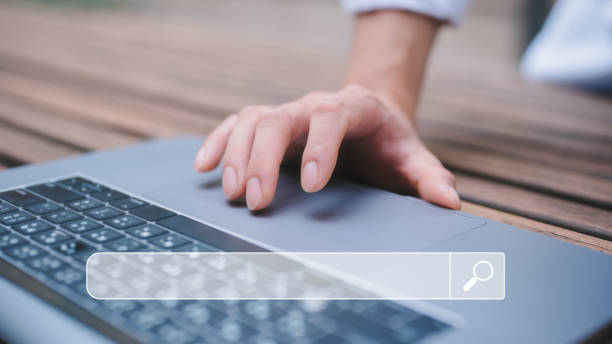 istock man hand touching on tack pad computer laptop in concept of search engine searching on internet 1949962650