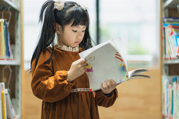 istock A girl reading books in the library 1949989123