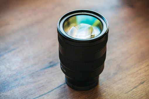 Close up of a camera lens on a desk.