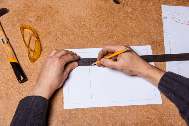 istock A carpenter works in a furniture workshop with various tools and a board 1950016459