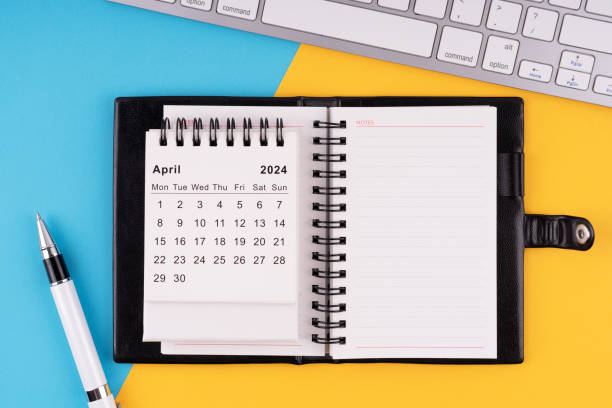 istock April 2024 calendar, notepad, pen and computer keyboard 1950016990
