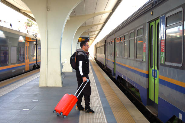 istock male at the train station 1950058336